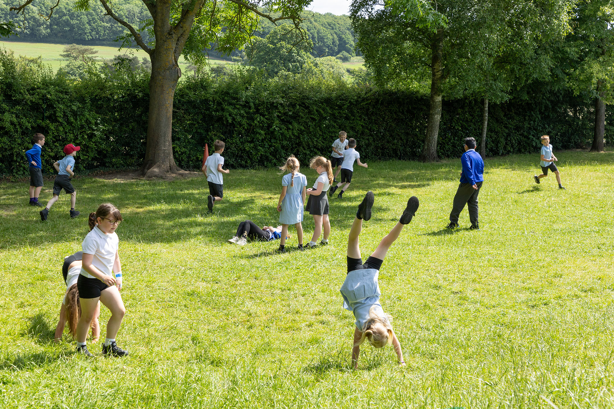 Children playing outdoors in the large grounds go Thornton Primary School